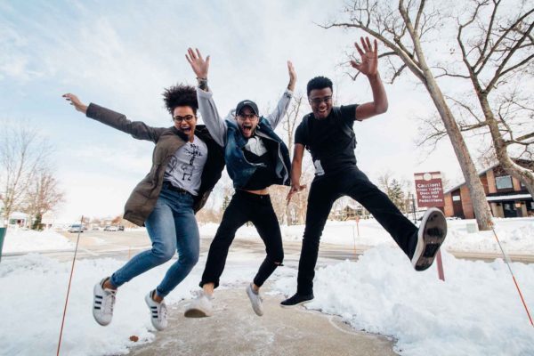 three young people jumping