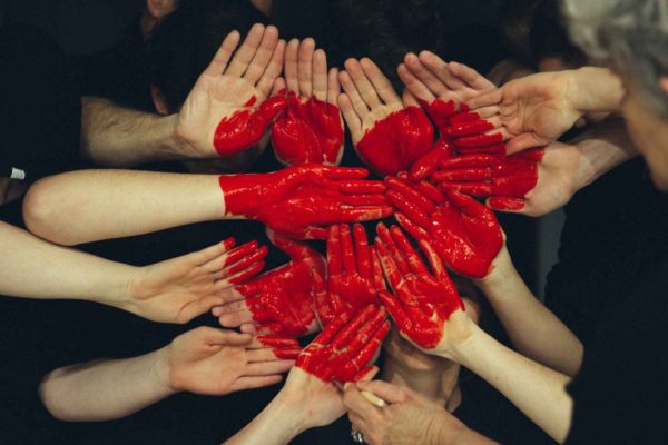 Heart shape of people holding hands