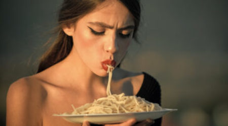 Diet and healthy organic food, italy. Chef woman with red lips eat pasta. Hunger, appetite, recipe. Woman eating pasta as taster or restaurant critic. Italian macaroni or spaghetti for dinner, cook Diet and healthy organic food, italy. Chef woman with red lips eat pasta. Hunger, appetite, recipe. Woman eating pasta as taster or restaurant critic. Italian macaroni or spaghetti for dinner, cook